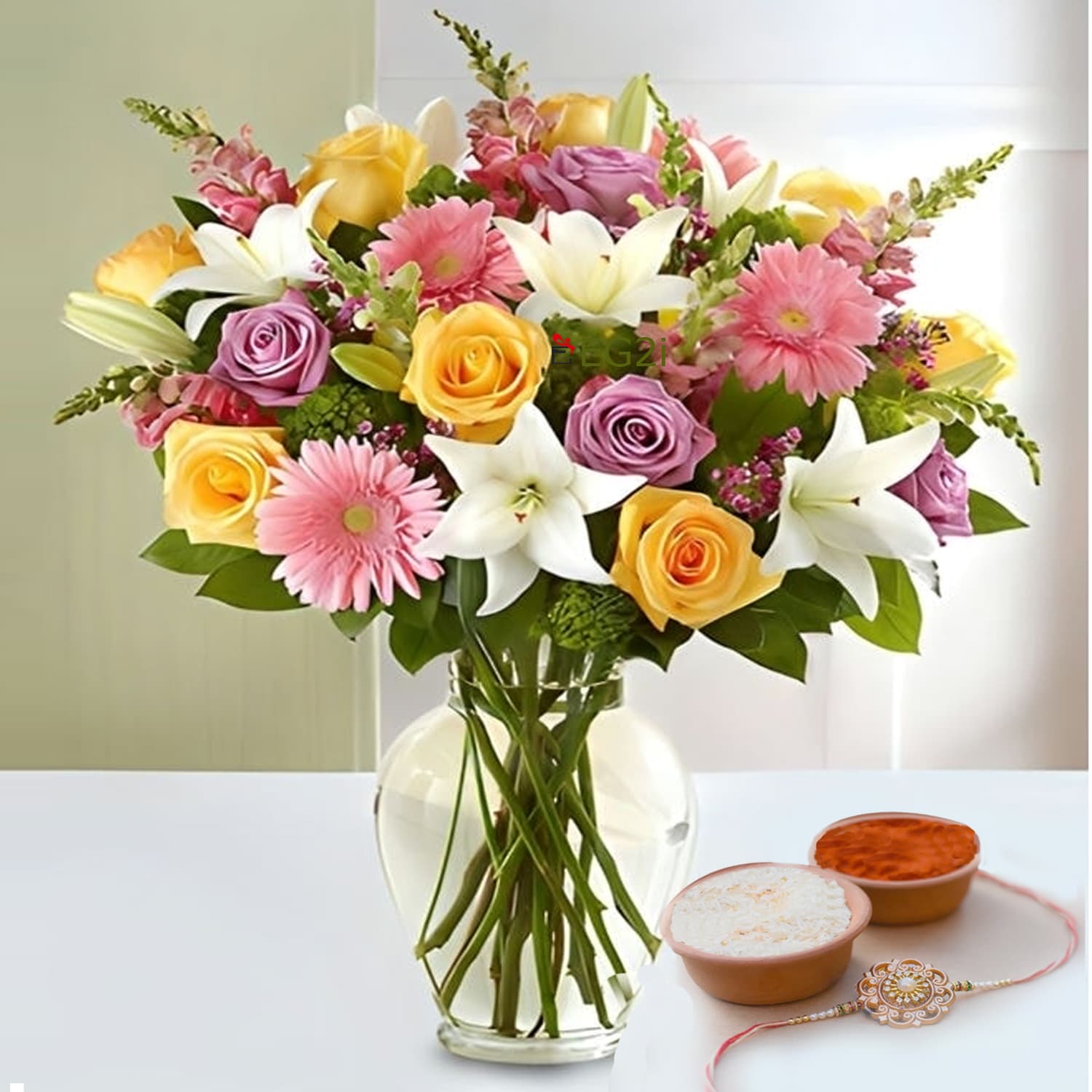 Mixed Seasonal Flowers in Glass Vase with Rakhi Roli Chawal